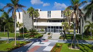 Modern campus building among palm trees