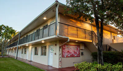Two-story campus building with an outdoor walkway