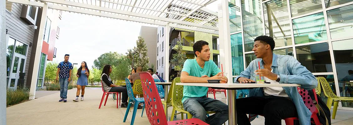 Students at outdoor tables on campus
